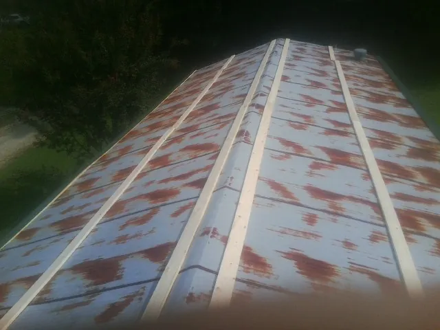Rusted metal roof panels with new wood purlins before replacement — Storm Damage Roof Repair in La Marque by Roofing Brothers